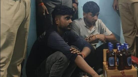 The two accused were caught with nine half-bottles of Imperial Blue filled with country liquor, 90 tetra packs of Twin Tower (labelled for sale in Uttar Pradesh), and several empty bottles of Royal Stag, White and Blue, After Dark, and 8 PM Whisky. (HT Photo) The two accused were caught with nine half-bottles of Imperial Blue filled with country liquor, 90 tetra packs of Twin Tower (labelled for sale in Uttar Pradesh), and several empty bottles of Royal Stag, White and Blue, After Dark, and 8 PM Whisky. (HT Photo)