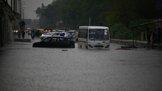 Commuters wade through a water logged stretch after rains at NH24 near Vinod Nagar (Raj K Raj/ Hindustan Times). Commuters wade through a water logged stretch after rains at NH24 near Vinod Nagar (Raj K Raj/ Hindustan Times).