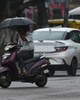 A scooterist braving the rain in Sector 22, Chandigarh, on Friday. The rain caused the mercury to drop to 31.1°C. (Keshav Singh/HT) A scooterist braving the rain in Sector 22, Chandigarh, on Friday. The rain caused the mercury to drop to 31.1°C. (Keshav Singh/HT)