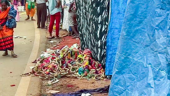 Belongings of the people scattered on the road after a stampede occurred at the Lairai Devi temple, in Shrigao, Goa, on Saturday. (ANI)