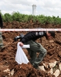 Israeli police officers investigate a crater at the site of a missile attack, launched from Yemen, near Ben Gurion Airport, in Tel Aviv, on Sunday. (REUTERS) Israeli police officers investigate a crater at the site of a missile attack, launched from Yemen, near Ben Gurion Airport, in Tel Aviv, on Sunday. (REUTERS)