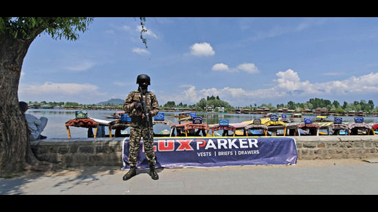 A soldier stands guard on the banks of the Dal Lake in Srinagar on Sunday. (Waseem Andrabi /HT) A soldier stands guard on the banks of the Dal Lake in Srinagar on Sunday. (Waseem Andrabi /HT)