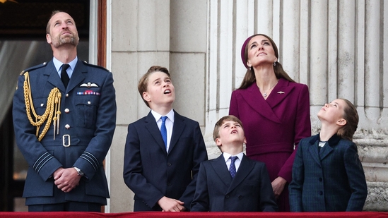 Prince William, Kate, and their children—Prince George, Princess Charlotte, and Prince Louis—gathered as a family on the Buckingham Palace balcony on May 5, 2025, to watch the Red Arrows flypast. (Photo by Adrian DENNIS / AFP)(AFP)