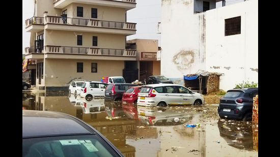 Vehicles parked in a waterlogged plot in Ashok Vihar in Gurugram. (HT PHOTO) Vehicles parked in a waterlogged plot in Ashok Vihar in Gurugram. (HT PHOTO)